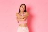 Asian girl hugging herself.jpg